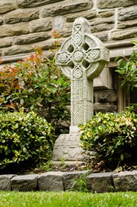 A stone cross adorning a memorial garden
