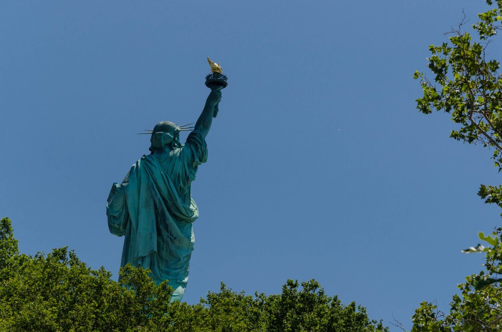Lady Liberty rises from the trees