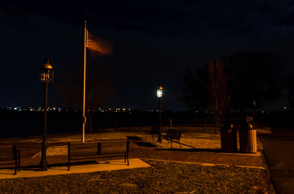 A flag whips in the breeze, becoming ghostly in a long exposure.