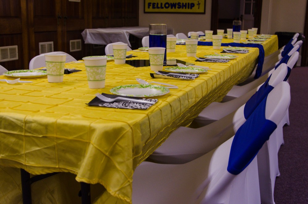 Covered chairs and lovely table linens make a drab social hall elegant