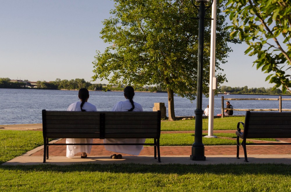 Two women on a bench overlooking the Delaware