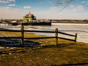 Boathouse jetting out into a frozen river