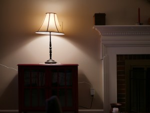 A lamp, shining out from its shade.