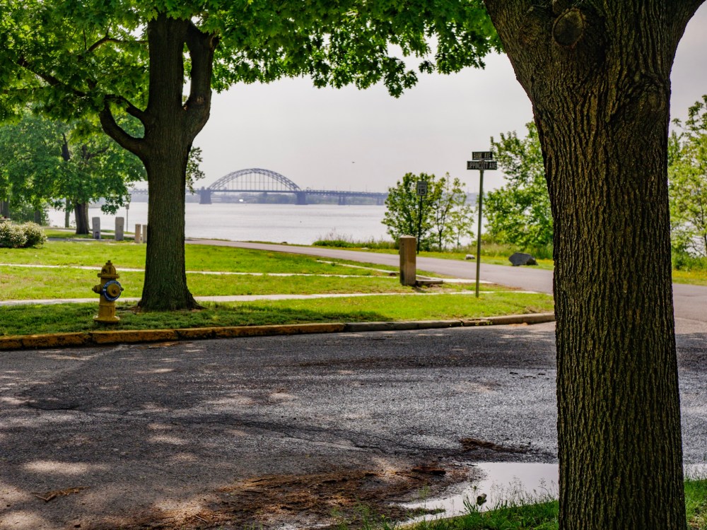 Looking at the Tacony-Palmyra Bridge across a hazy river