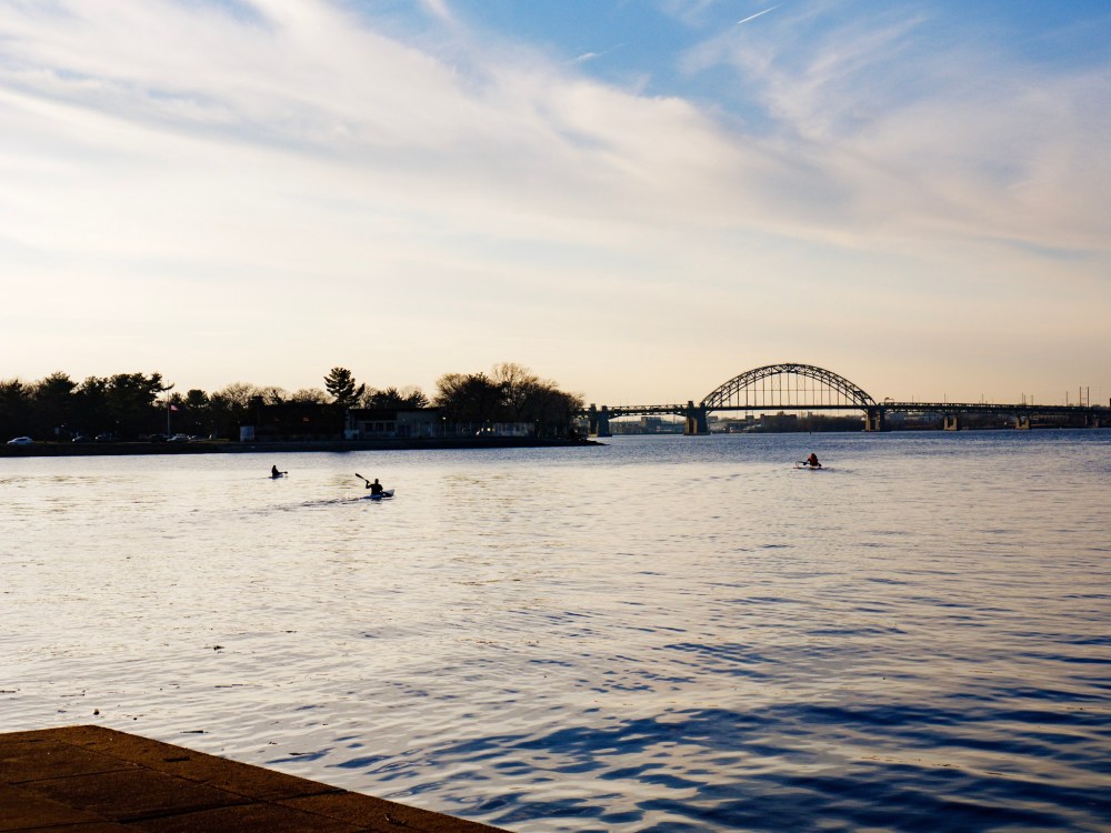 Kayakers paddle down toward the Tacony-Palmyra Bridge