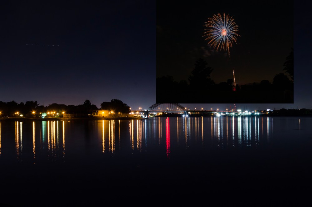 Nighttime photo of the Tacony-Palmyra Bridge. An unmasked firework photo is in the sky.